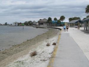 Nice sidewalk, sand, but not next to the water.