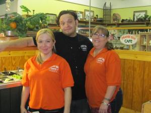 L to R: Nicole, cook Robert, and Libby in front of the salad bar with the Antique store in background