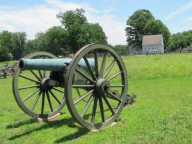 Artillery cannon with the plantation buildings in the background