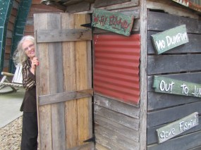 Sher in the two hole outhouse